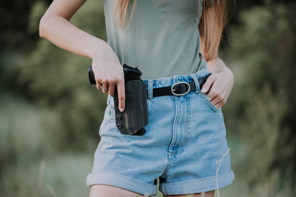 Woman with a conceal carry pistol holster