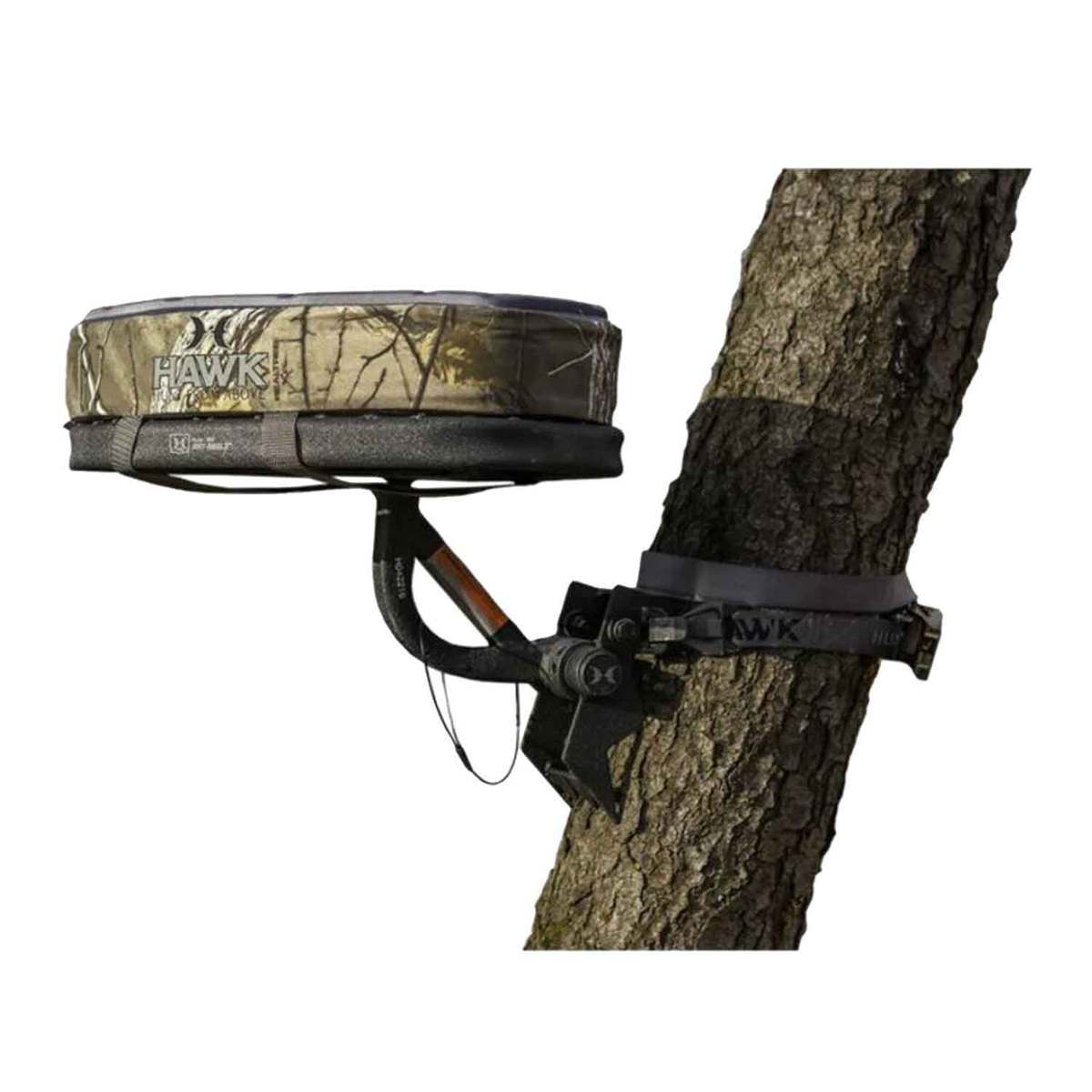 https://www.sportsmans.com/medias/hawk-any-angle-tree-seat-1688950-1.jpg?context=bWFzdGVyfGltYWdlc3w3MDg4MnxpbWFnZS9qcGVnfGltYWdlcy9oZDMvaGE3Lzk3Njc2ODcwOTQzMDIuanBnfDY5YTIwZTBlOTQ1OTM3NmMwNTJiZGQ5NThhNjYwNzJlODdmYzU5MGM1MDFmMWY5YjJiMTlhMmI3NmRjMjg4NDU